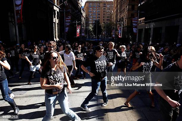 Members of the Make Poverty History campaign dance during a musical flash mob performance at Martin Place on May 11, 2010 in Sydney, Australia. The...