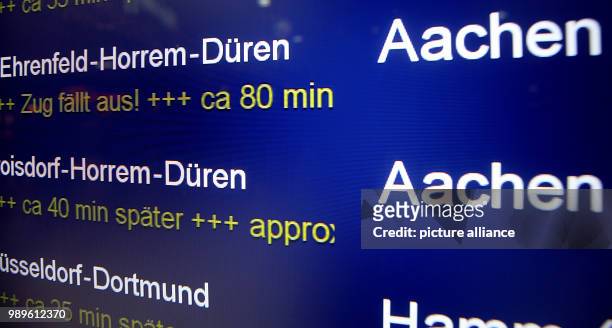 An information board shows the train cancellations and delays at the main station in Cologne, Germany, 03 January 2018. From early morning, the...