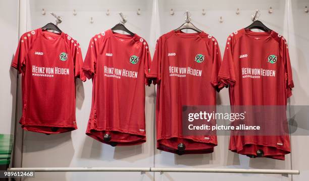 July 2018, Germany, Hanover: The new home kit for the 2018/2019 season from Hanover 96 hanging in the 96-fan shop. Photo: Julian Stratenschulte/dpa