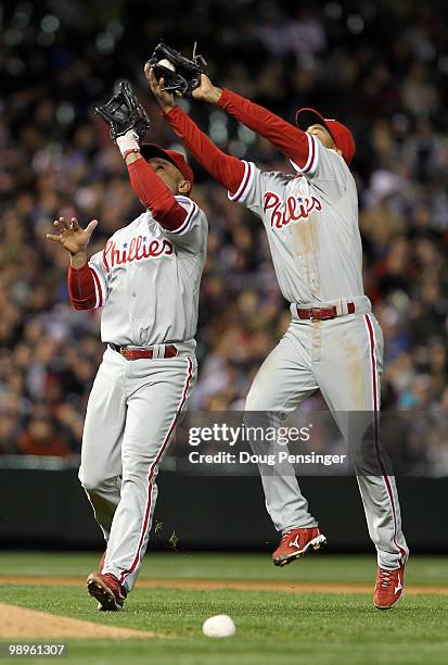 Shortstop Wilson Valdez of the Philadelphia Phillies collides with third baseman Placido Polanco as he catches a pop up by Clint Barmes the Colorado...