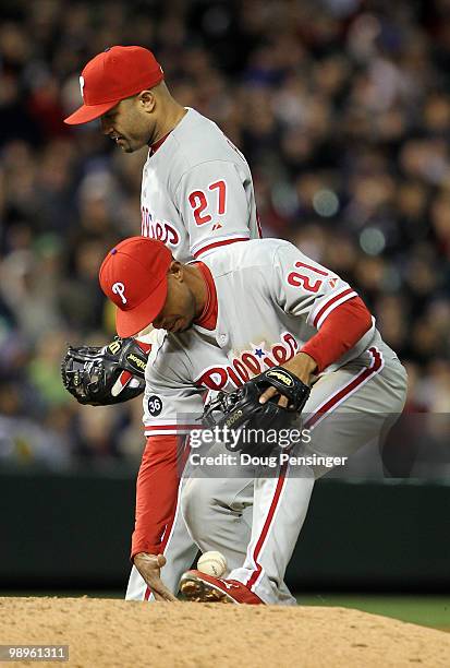 Shortstop Wilson Valdez of the Philadelphia Phillies bobbles the ball in front of teammate Placido Polanco as he catches a pop up by Clint Barmes the...