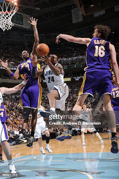 Paul Millsap of the Utah Jazz goes to the hoop against Lamar Odom and Pau gasol of the Los Angeles Lakers in Game Four of the Western Conference...