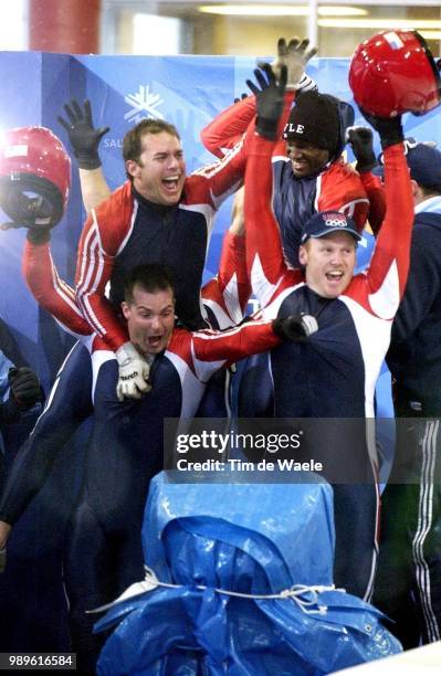 Winter Olympic Games : Salt Lake City, 02/23/02, Park City, Utah, United States --- Brian Shimer Leaps Up Behind Mike Kohn As The Two Usa Bobsleigh...