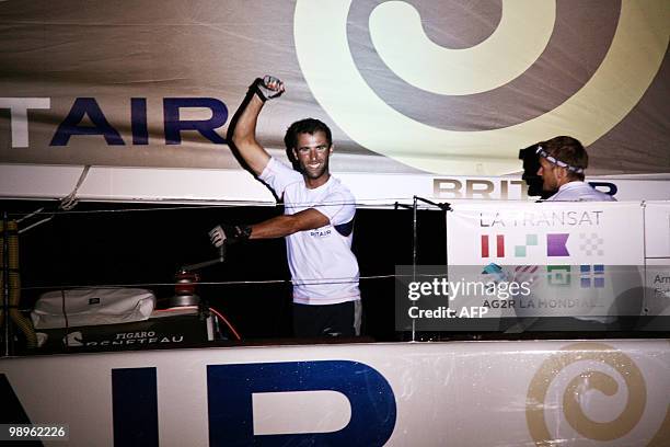 French skippers Armel Le Cleac'h and Fabien Delahaye celebrate on their "Brit Air" monohull after winning the AG2R La Mondiale sailing race between...