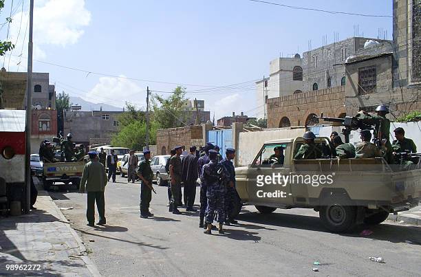Yemeni security forces guard the area around Sanaa's penal court during a hearing in the case of an arrested arms dealer on May 11, 2010. Tribal...