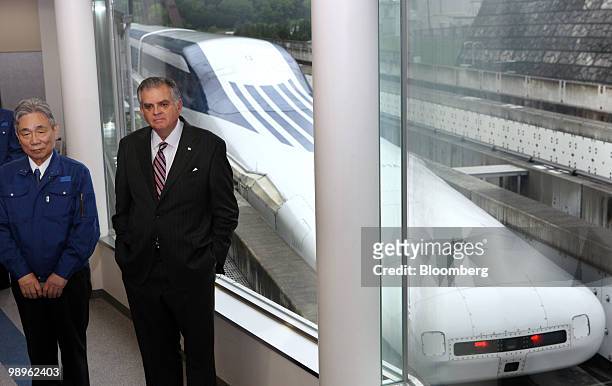 Ray LaHood, U.S. Transportation secretary, right, and Yoshiyuki Kasai, chairman of Central Japan Railway Co., speak to the media after riding on a...
