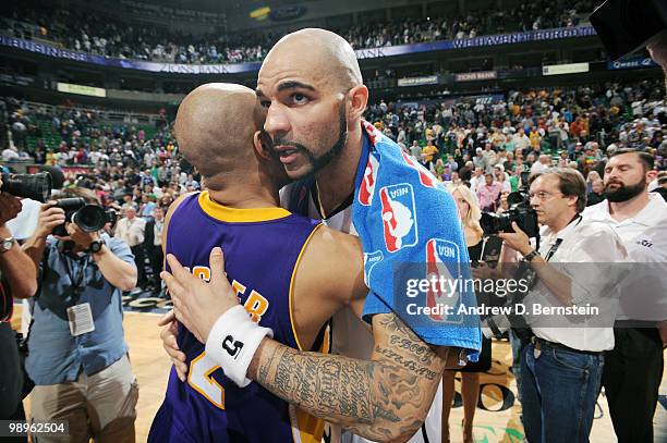 Carlos Boozer of the Utah Jazz hugs Derek Fisher of the Los Angeles Lakers in Game Four of the Western Conference Semifinals during the 2010 NBA...