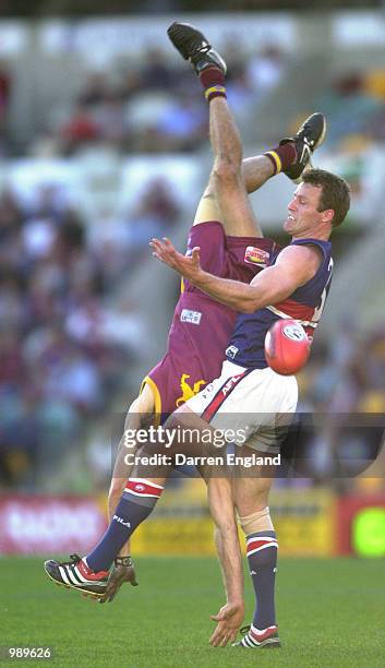 Darryl White of Brisbane fails to take a mark against Chris Grant of the Bulldogs during the round 18 AFL match between the Brisbane Lions and the...