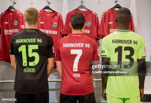 July 2018, Germany, Hanover: Players Timo Huebers , Edgar Prib and Ihlas Bebou from Hanover 96 presenting their new kits for the 2018/2019 season....