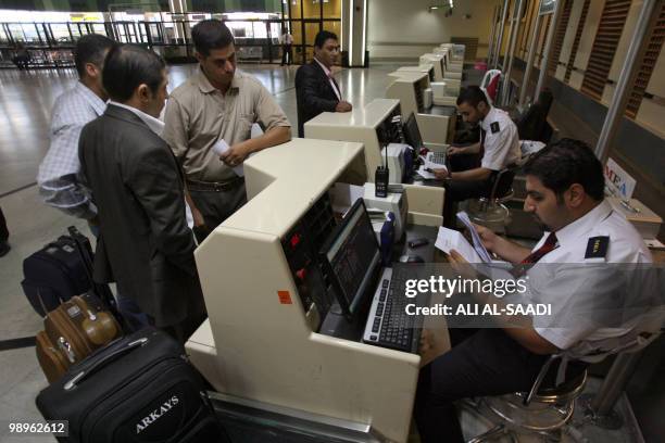 Passengers check in at Baghdad International Airport on April 24, 2010. More than a decade of UN sanctions followed Saddam Hussein's August 1990...