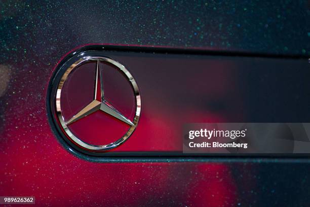 The Mercedes Benz AG logo sits on a Daimler AG Mercedes-Benz G-Class vehicle as it sits on display during its debut at an event during the 2018 North...
