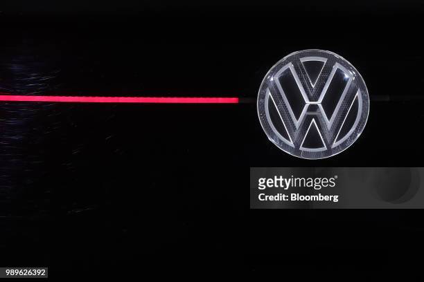 Badge sits illuminated on a Volkswagen I.D. Crozz electric vehicle, manufactured by Volkswagen AG , during the CeBIT 2018 tech fair in Hanover,...