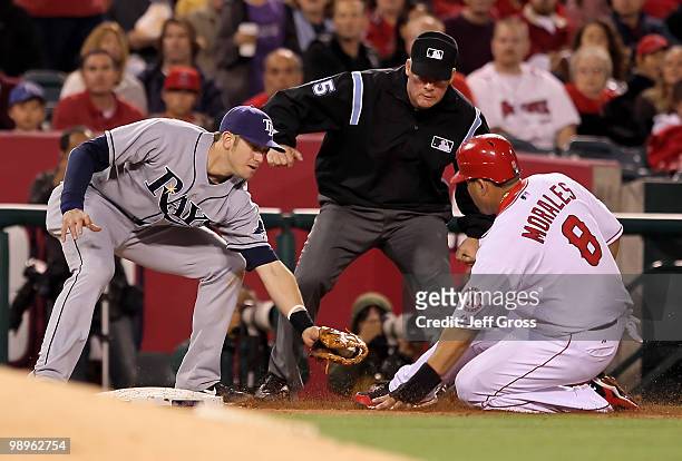 Kendry Morales of the Los Angeles Angels of Anaheim is caught stealing third base by Evan Longoria of the Tampa Bay Rays in the third inning at Angel...