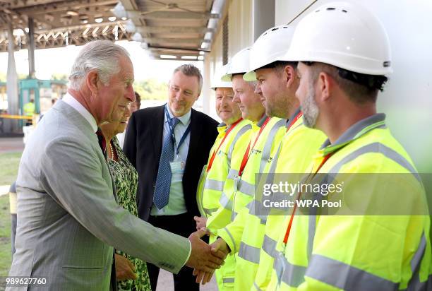 The Prince of Wales and Duchess of Cornwall meet maintenance workers during their visit to the toll plaza office at the Second Severn Crossing on...