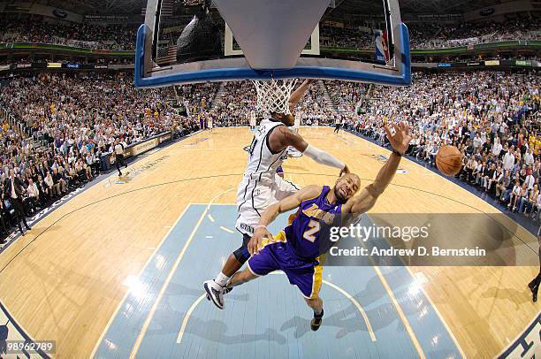 Derek Fisher of the Los Angeles Lakers gets fouled on the way to the basket by C.J. Miles of the Utah Jazz in Game Four of the Western Conference...