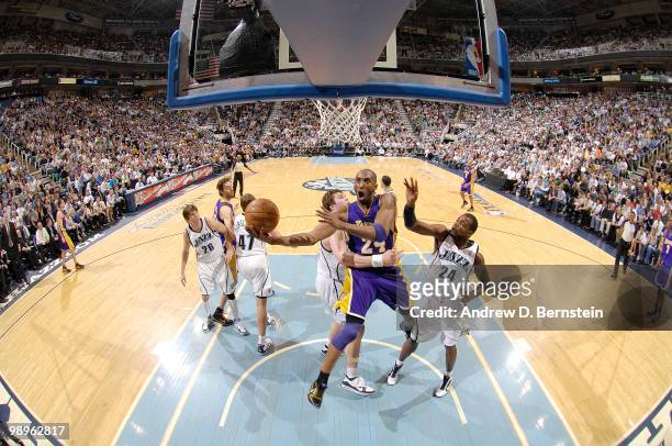 Kobe Bryant of the Los Angeles Lakers get fouled on the way to the basket by Kyrylo Fesenko of the Utah Jazz in Game Four of the Western Conference...