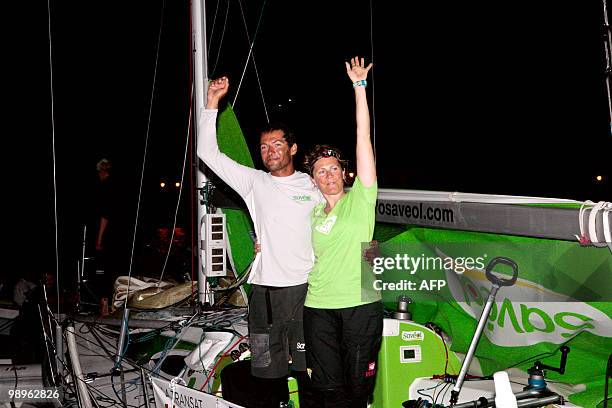 British skipper Samantha Davies and French teammate Romain Attanasio wave on their "Saveol" monohull after finishing the AG2R La Mondiale sailing...