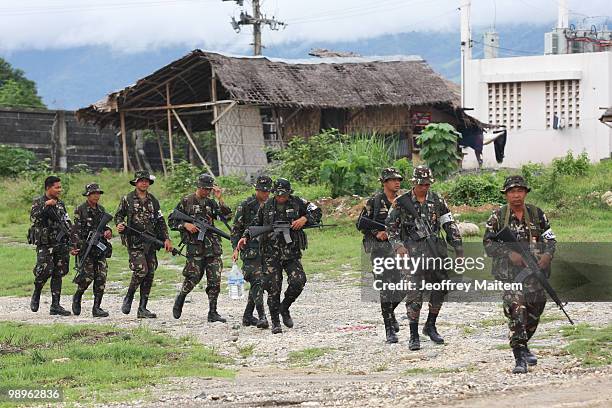 Philippine soldiers secure the area of the provincial capitol as vote counting continues to try to determine the next President of the Philippines on...