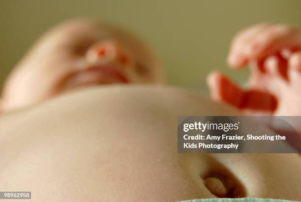 a close up view of a baby's belly button - shooting up stock pictures, royalty-free photos & images