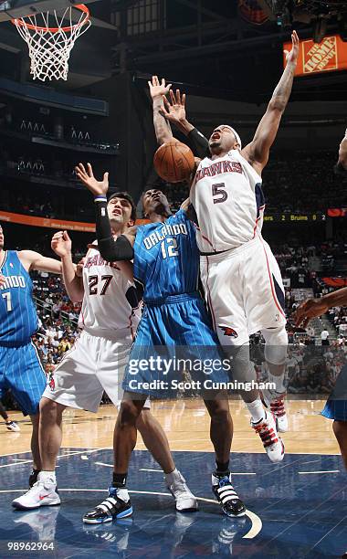 Josh Smith of the Atlanta Hawks is fouled by Dwight Howard of the Orlando Magic in Game Four of the Eastern Conference Semifinals during the 2010 NBA...