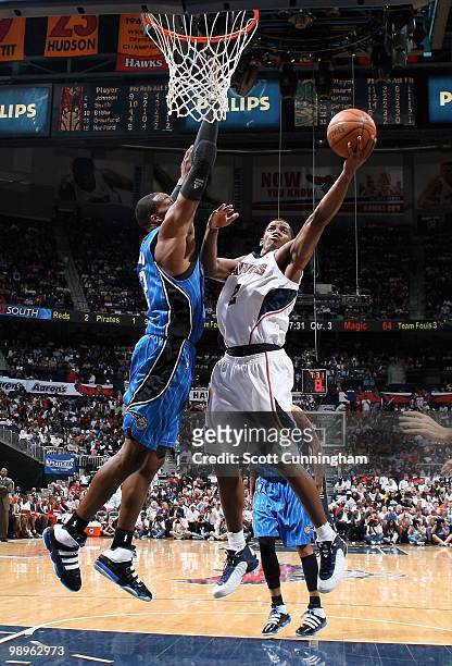 Joe Johnson of the Atlanta Hawks puts up a shot against Dwight Howard of the Orlando Magic in Game Four of the Eastern Conference Semifinals during...