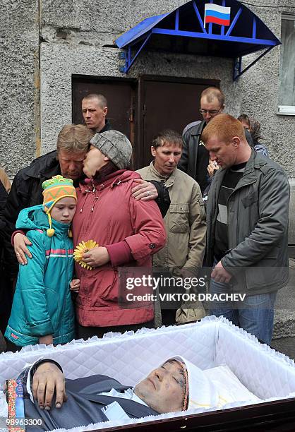 Relatives mourn by the coffin of Alexander Gorbunov, a miner killed at the Raspadskaya mine, during a funeral ceremony in the city of Mezhdurechensk...