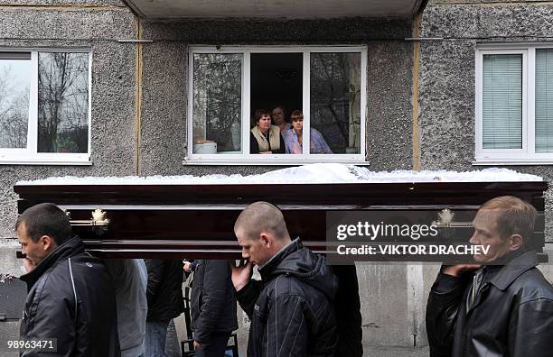 People carry the coffin of Alexander Gorbunov, a miner killed at the Raspadskaya mine, during a funeral ceremony in the city of Mezhdurechensk in the...