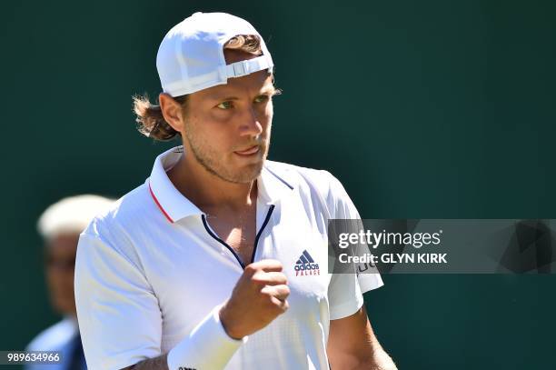 France's Lucas Pouille celebrates a point against US player Denis Kudla during their men's singles first round match on the first day of the 2018...