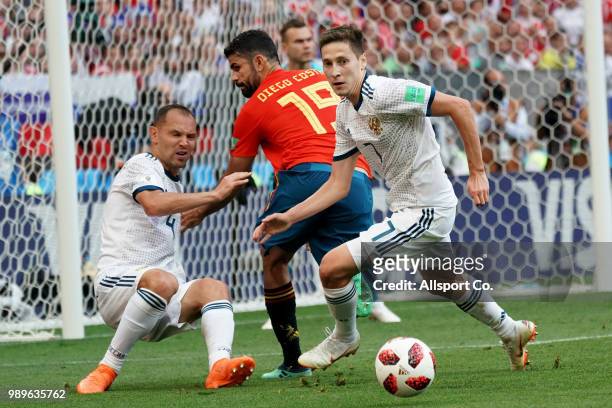 Sergey Ignaschevich and Daler Kuziaev of Russia battles with Diego Costa of Spain during the 2018 FIFA World Cup Russia Round of 16 match between...