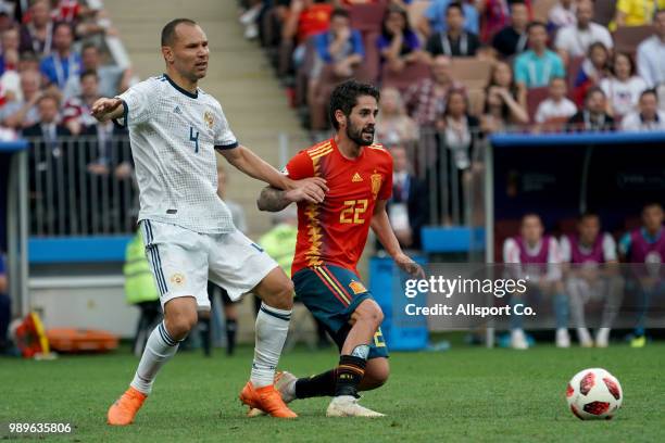 Sergey Ignashevich of Russia holds Isco of Spain during the 2018 FIFA World Cup Russia Round of 16 match between Spain and Russia at Luzhniki Stadium...