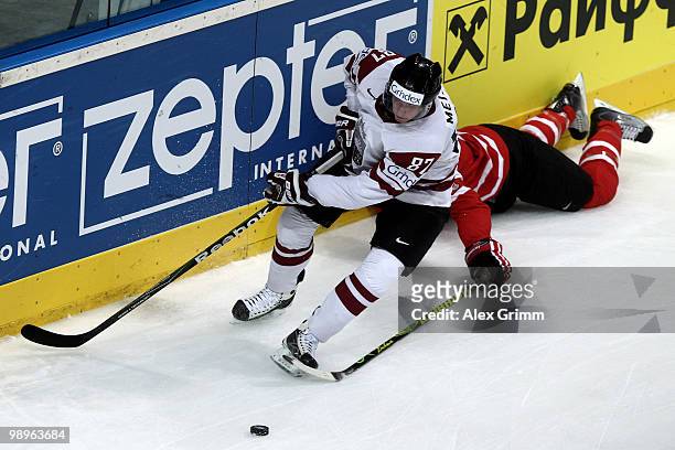 Gints Meija of Latvia is challenged by Brent Burns of Canada during the IIHF World Championship group B match between Switzerland and Italy at SAP...