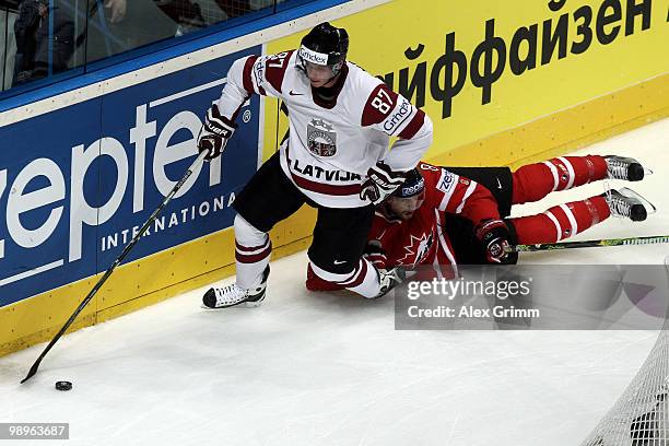 Gints Meija of Latvia is challenged by Brent Burns of Canada during the IIHF World Championship group B match between Switzerland and Italy at SAP...