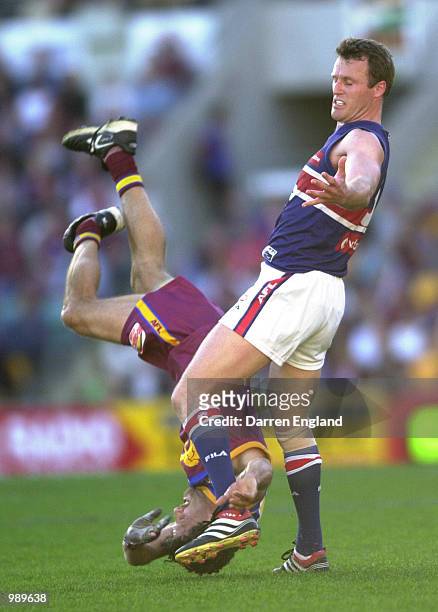 Darryl White of Brisbane fails to take a mark against Chris Grant of the Bulldogs during the round 18 AFL match between the Brisbane Lions and the...