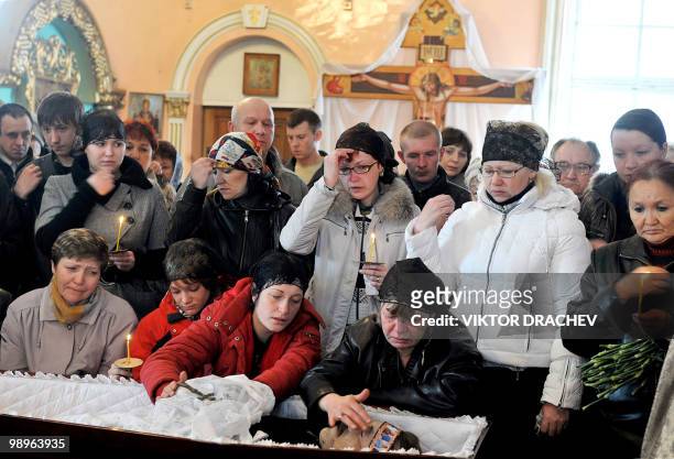 Relatives and friends mourn a miner killed in explosions at the Raspadskaya mine, during a funeral ceremony in the city of Mezhdurechensk in the west...