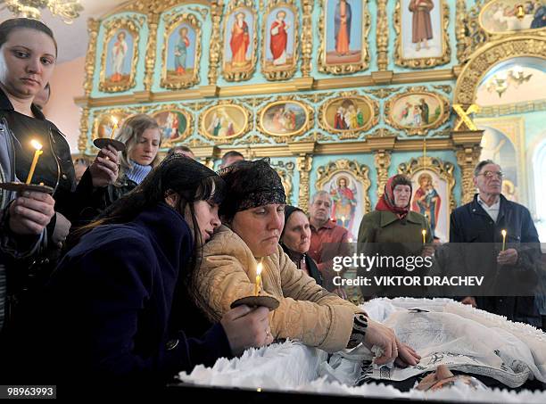 Relatives and friends mourn a miner killed in explosions at the Raspadskaya mine, during a funeral ceremony in the city of Mezhdurechensk in the west...