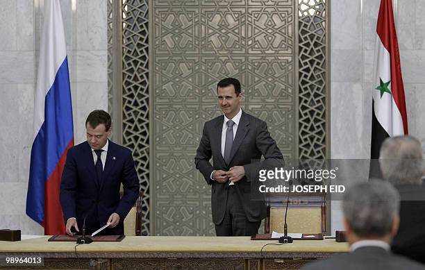 Russian President Dmitry Medvedev and his Syrian counterpart Bashar al-Assad leave at the end of their press conference at Al-Shaab presidential...