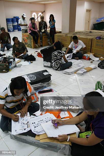 Board of Election inspectors work at the old provincial capitol of Maguindanao as vote counting continues to try to determine the next President of...