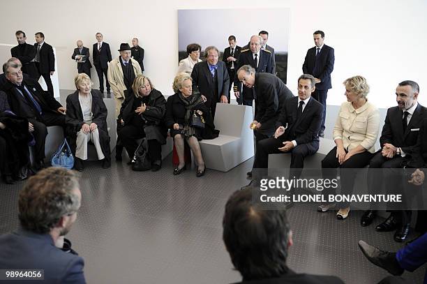 French President Nicolas Sarkozy speaks with artists seated in a room of the new branch of Paris' Pompidou Centre modern art museum in Metz, eastern...