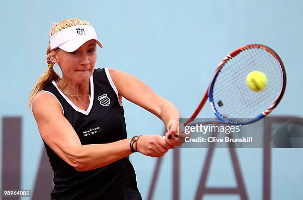 Olga Govortsova of Belarus plays a backhand against Lucie Safarova of Czech Republic in their second round match during the Mutua Madrilena Madrid...