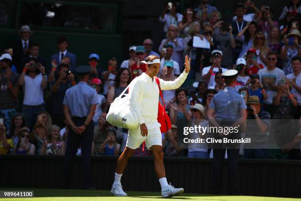 Roger Federer of Switzerland walks out onto the court ahead of his Men's Singles first round match against Dusan Lajovic of Serbia on day one of the...