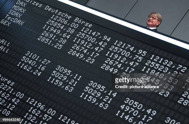 July 2018, Germany, Frankfurt: Chairman of the Deutsche Boerse AG, Theodor Weimer , Frank Mella, standing over a display board with the indexes of...