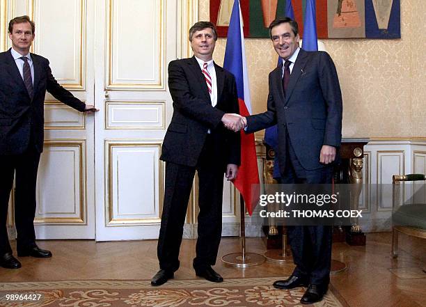 Czech Prime Minister Jan Fischer shakes hands with his French counterpart Francois Fillon during a meeting at the Hotel Matignon in Paris on May 11,...