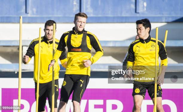 Dortmund's Sokratis Papastathopoulos, Marco Reus and Shinji Kagawa warm up during a training session at the training camp of the German Bundesliga...