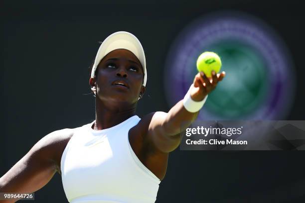 Sloane Stephens of the United States serves to Donna Vekic of Croatia during their Ladies' Singles first round match on day one of the Wimbledon Lawn...