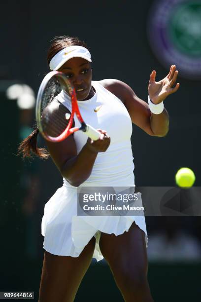 Sloane Stephens of the United States serves to Donna Vekic of Croatia during their Ladies' Singles first round match on day one of the Wimbledon Lawn...