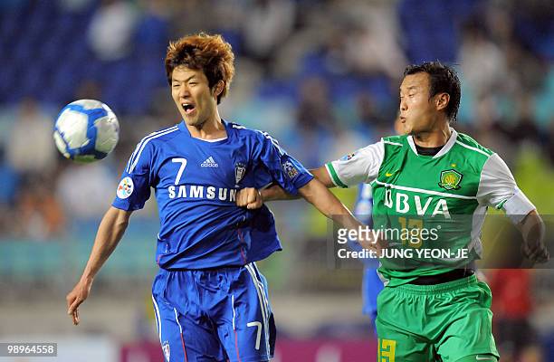 Lee Sang-Ho of South Korea's Suwon Bluewings and Xu Yunlong of China's Beijing Guoan fight for the ball during the AFC Champions League round 16...