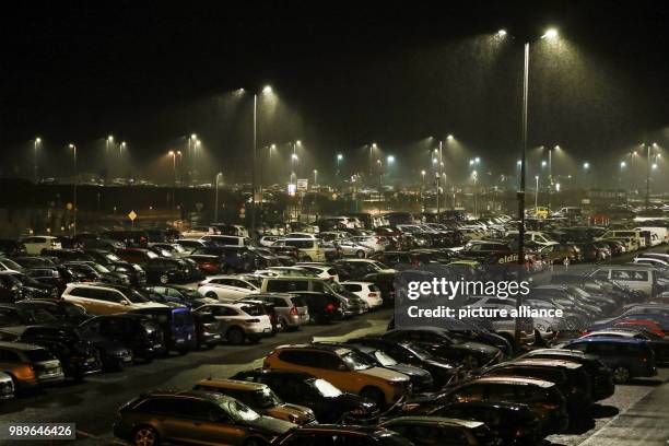 Numerous cars are parked in the early morning hours in front of a ferry terminal in Norddeich, Germany, 4 January 2018. Photo: Mohssen...