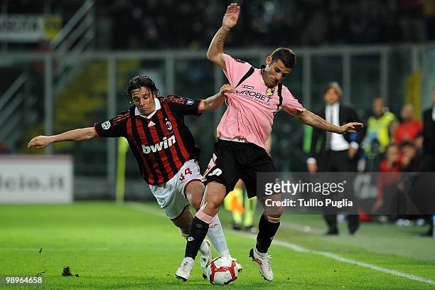 Massimo Oddo of Milan and Antonio Nocerino of Palermo compete for the ball during the Serie A match between US Citta di Palermo and AC Milan at...