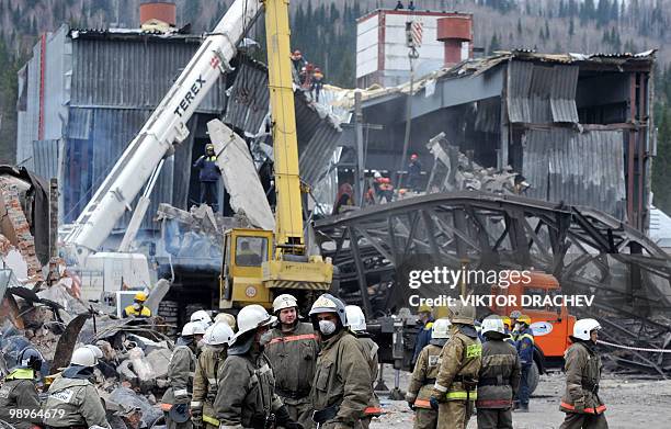 Emergency workers remove debris at the site of an underground explosion, at the Raspadskaya mine in the city of Mezhdurechensk in the west Siberian...