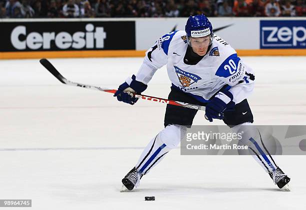 Antti Miettinen of Finland runs with the puck during the IIHF World Championship group A match between Germany and Finland at Lanxess Arena on May...